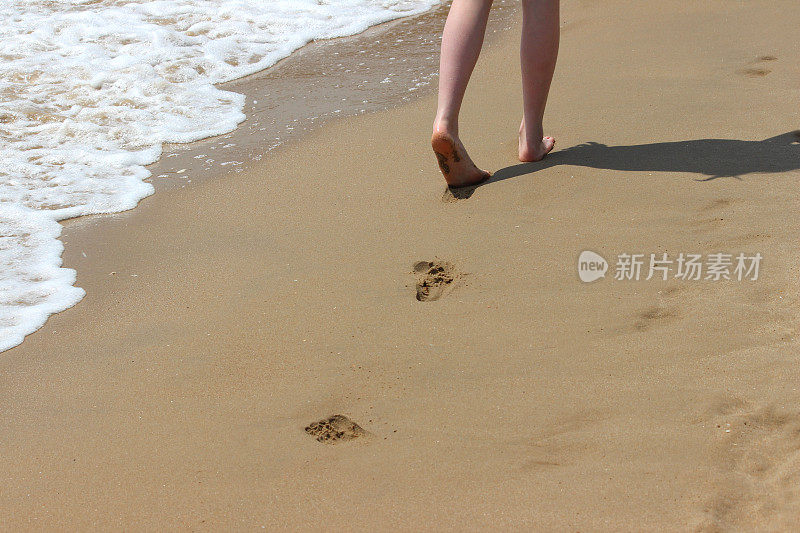 沙滩上的脚印，海边的脚印，光着脚的女孩/腿